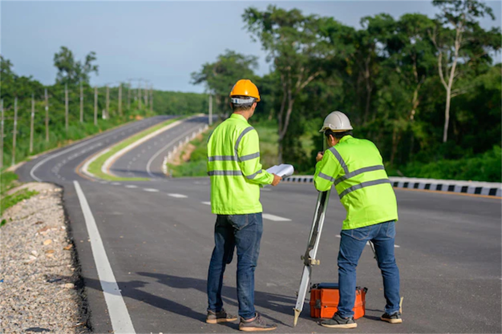 picture-two-civil-engineers-using-theodolites-measuring-land-coordinates-standing-outdoor-theodolites-road-construction-site_140555-1135